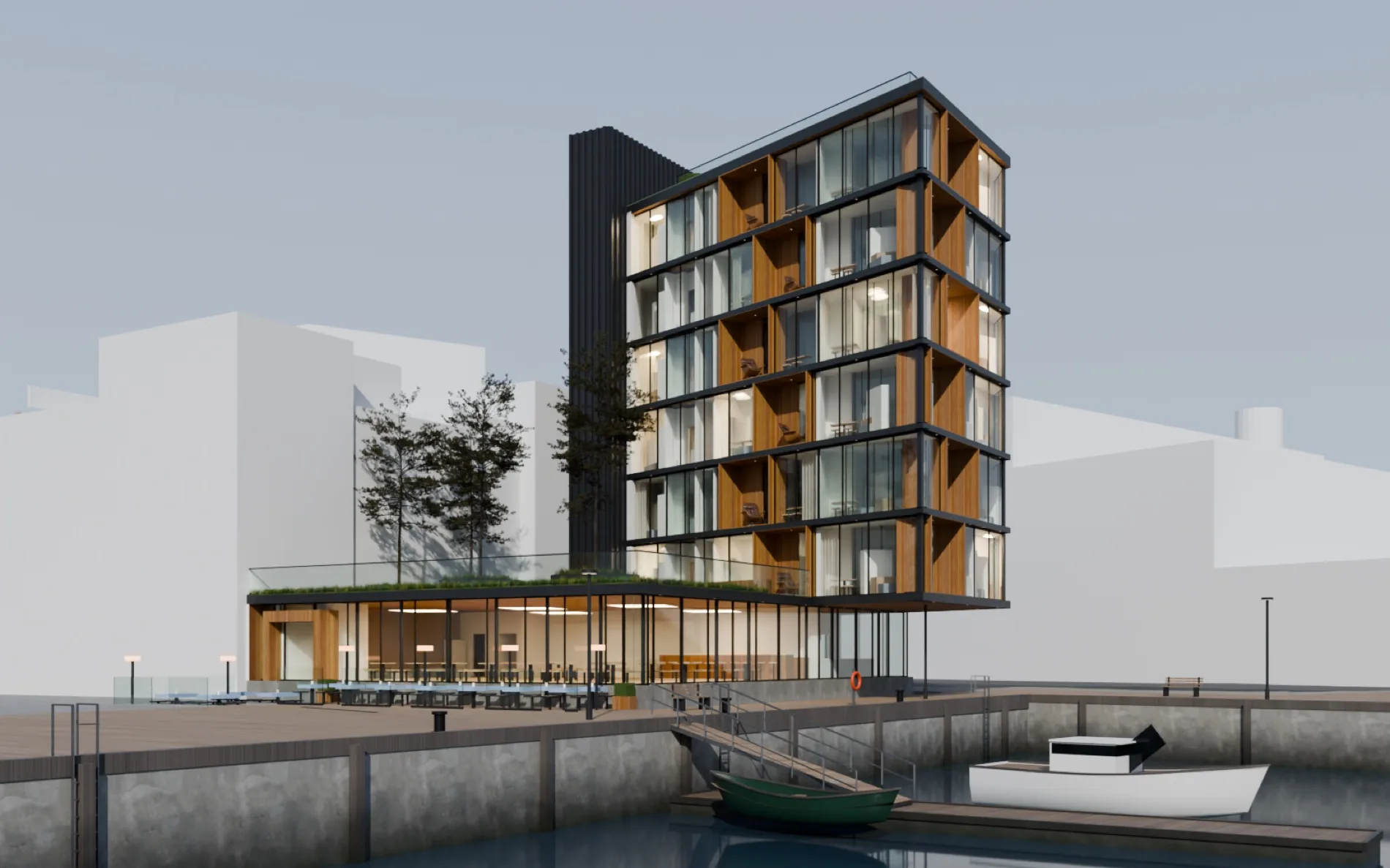 Bygget på Paul Bjørvigs brygge sett fra bassenget på dagtid, med plankekai og båter