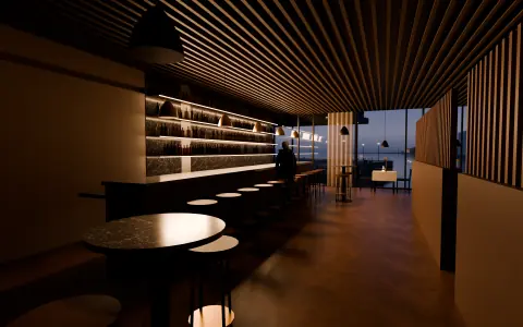 Restauranten sett fra baren, med høye krakker og vinduer mot sjøen, skumring