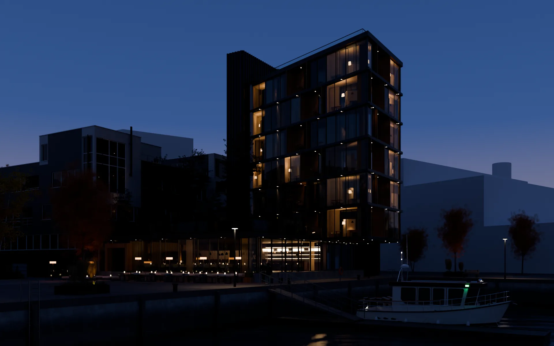 Bygget sett fra bassenget i skumring