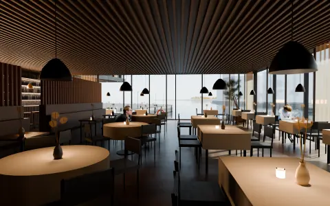 Spisesalen med dekkede bord og vinduer mot sjøen, dag