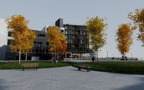 Bygget sett fra torget med bjørk og benker, dag